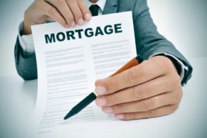 A mortgage loan being presented with a pen