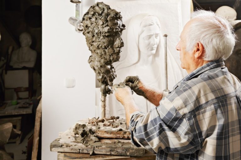 Artist working on his sculpture