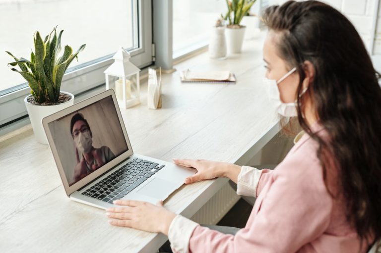 woman wearing a mask while on a video meeting